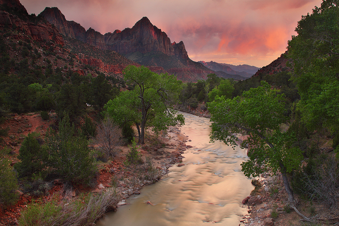 The fleeting sun sets an evening storm ablaze over The Watchman and the Virgin River in Zion National Park.&nbsp;