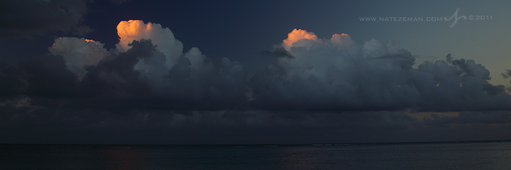 The last light of the setting sun touches just the top of a beautiful cloud bank.